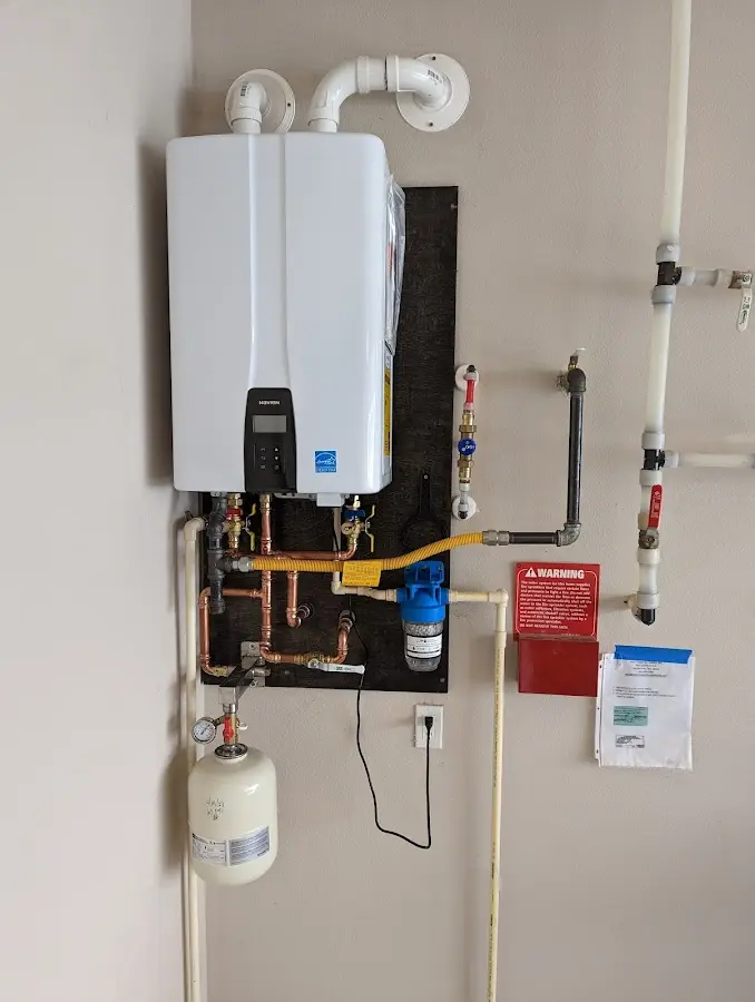 Professional plumber installing copper piping in a Onondaga home